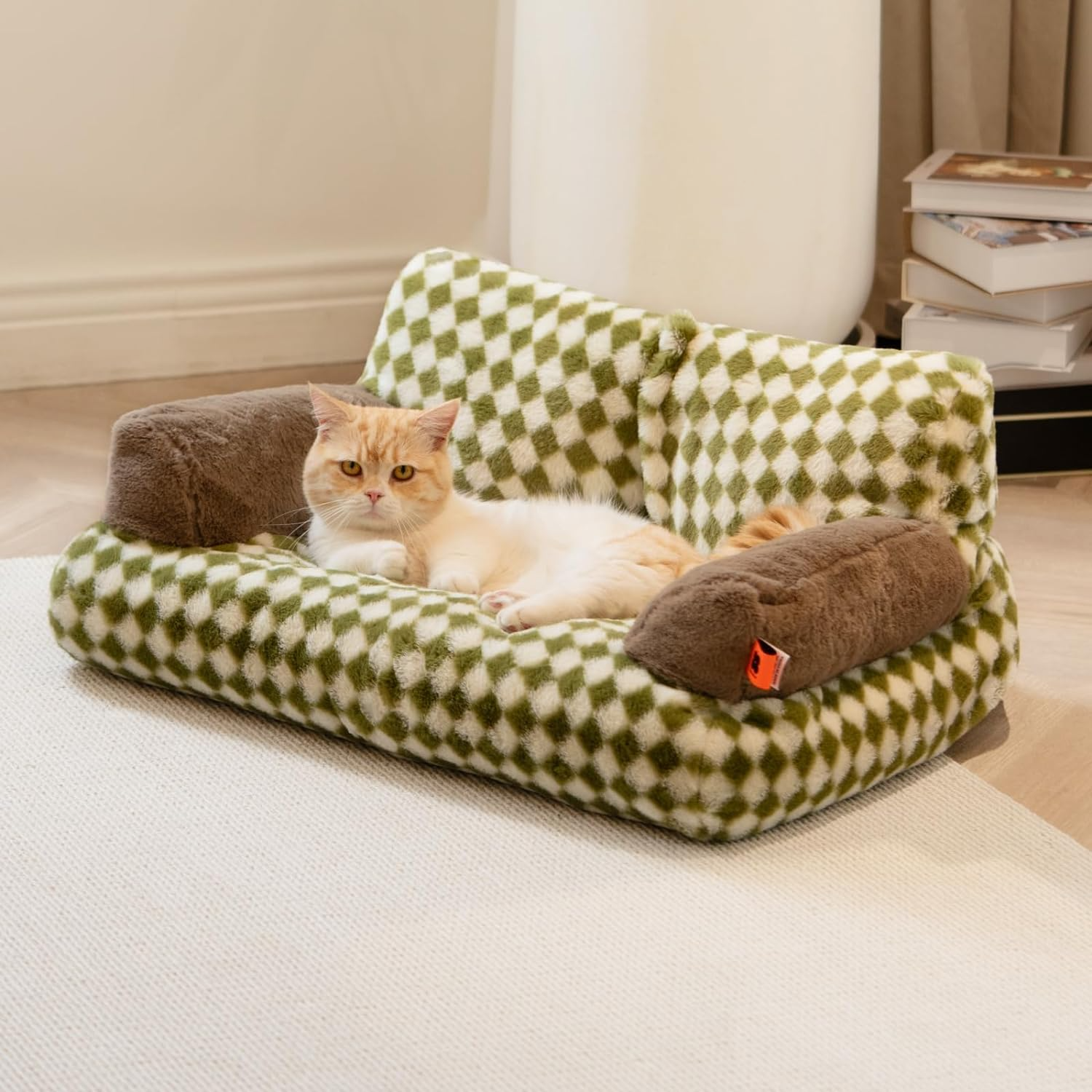 Cat lying on a green checkered pet bed with brown cushions in a home setting.