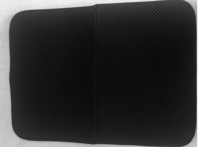 Black textured mouse pad on a white background