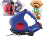 Blue and red retractable dog leash with packaging and a small dog wearing a striped shirt.