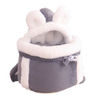 Gray pet carrier with white interior and fluffy ears on a white background