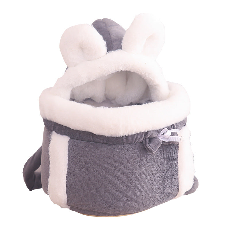 Gray pet carrier with white interior and fluffy ears on a white background