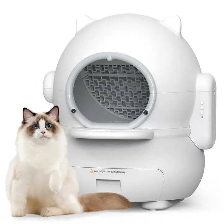 White self-cleaning litter box with a cat sitting next to it on a white background