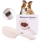 Dog measuring spoon with digital display, dog food, and two dogs on a white background