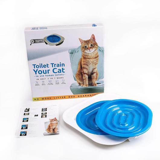 Cat toilet training kit with packaging, blue lids, and leaflets on a white background