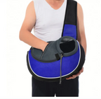 Person holding a blue and black pet carrier against a white background