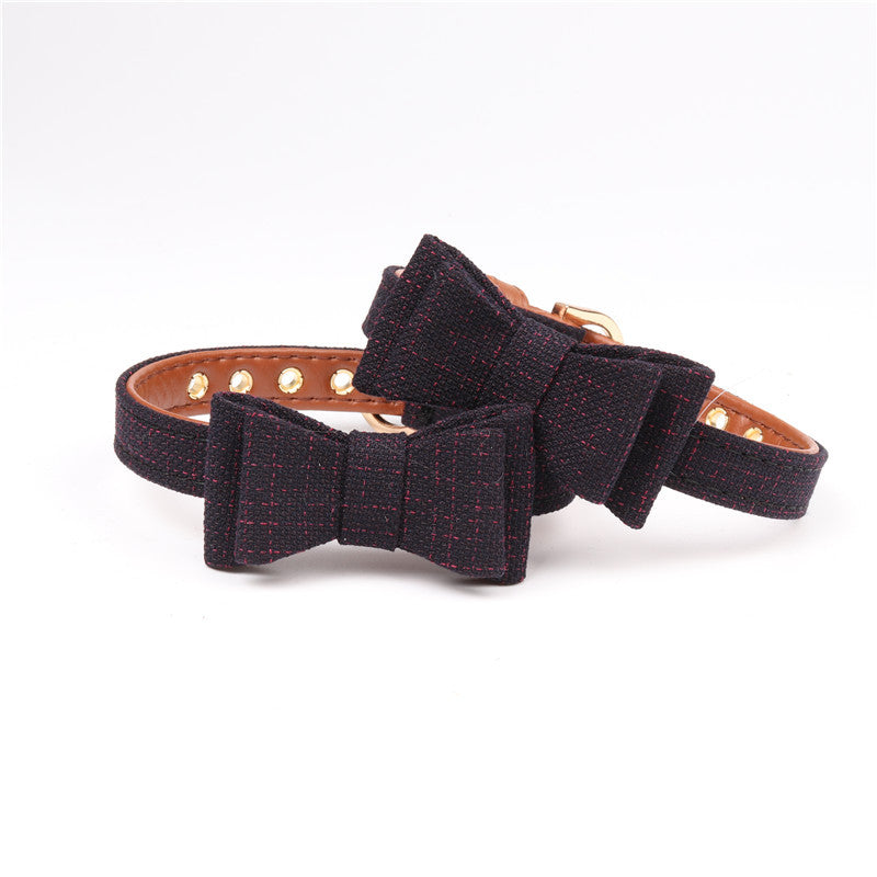 Dog collar with a large black bow on a white background