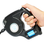 hand holding a retractable dog leash with flashlight on white background