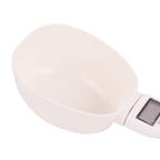 White handheld device with a digital display on a white background