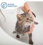 Cat being bathed with water resistant label above