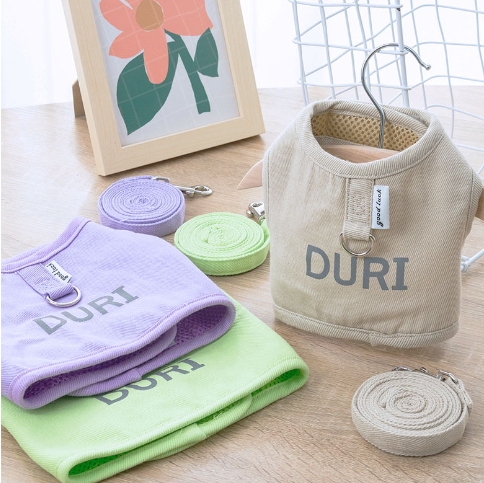 cat harnesses and accessories with 'DURI' branding on a wooden surface.