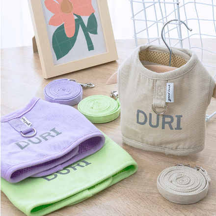 cat harnesses and accessories with 'DURI' branding on a wooden surface.