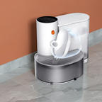 White and gray pet water fountain on a tiled floor with a brown wall background