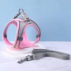 Pink and gray cat harness with a matching leash on a light blue background