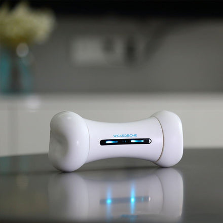 White electronic device with blue lights on a reflective surface