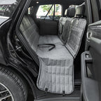 Car interior with gray bench seat covers and a visible seat belt.