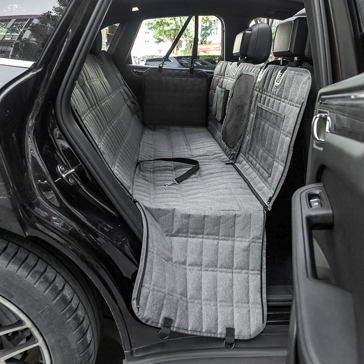 Car interior with gray bench seat covers and a visible seat belt.