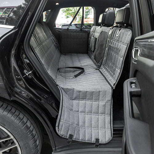 Car interior with gray bench seat covers and a visible seat belt.