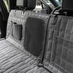 Gray car bench seat cover with storage pockets and a mesh panel in a vehicle.