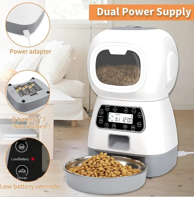Pet food dispenser with dual power supply and bowl of food on a wooden floor.