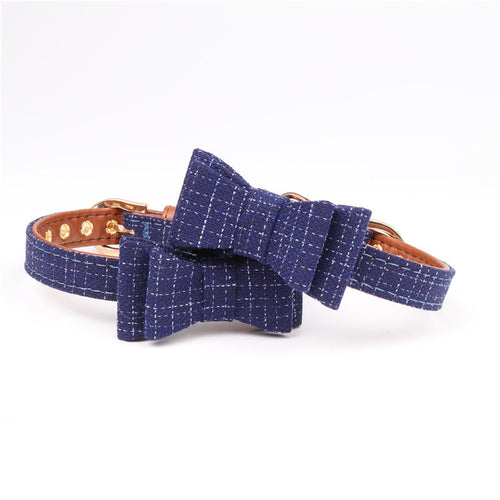 Blue textured dog collar with a bow on a white background