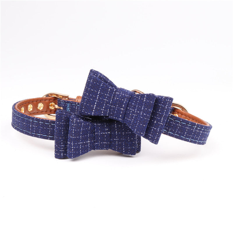 Blue textured dog collar with a bow on a white background
