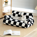 Black and white checkered stylish pet bed with a cat inside, on a carpeted floor.