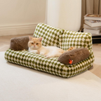 Cat lying on a green checkered pet bed with brown cushions in a home setting.