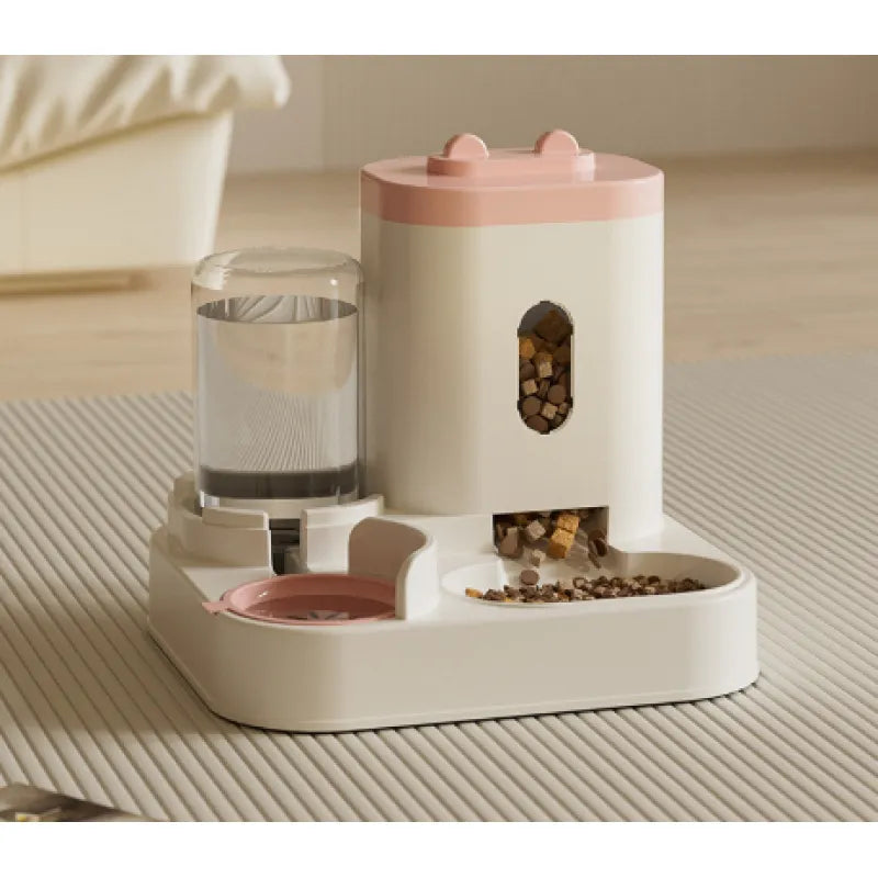 automatic gravity pet feeder and water dispenser with a pink top on a textured surface.